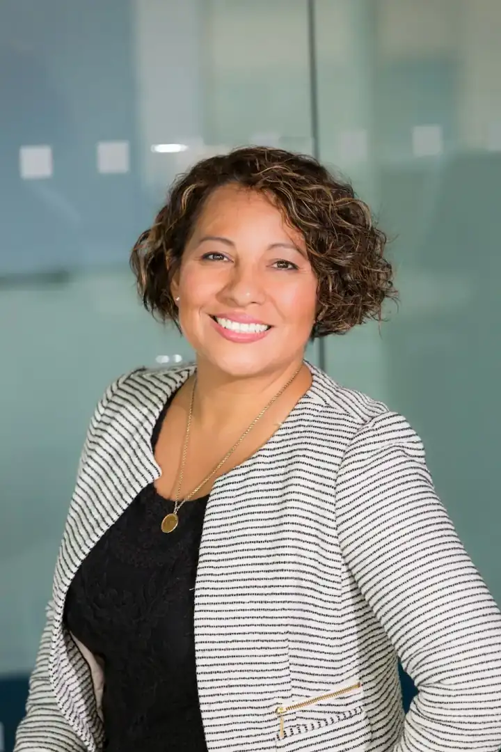 Brown-skinned professional speaking in an interview