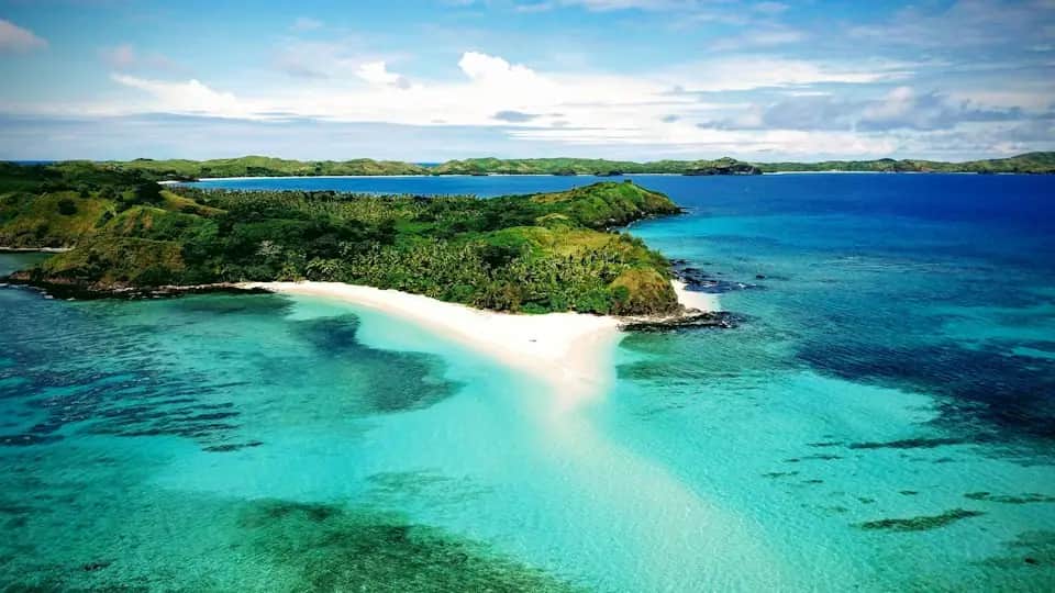 Blue water and green shoreline in Fiji