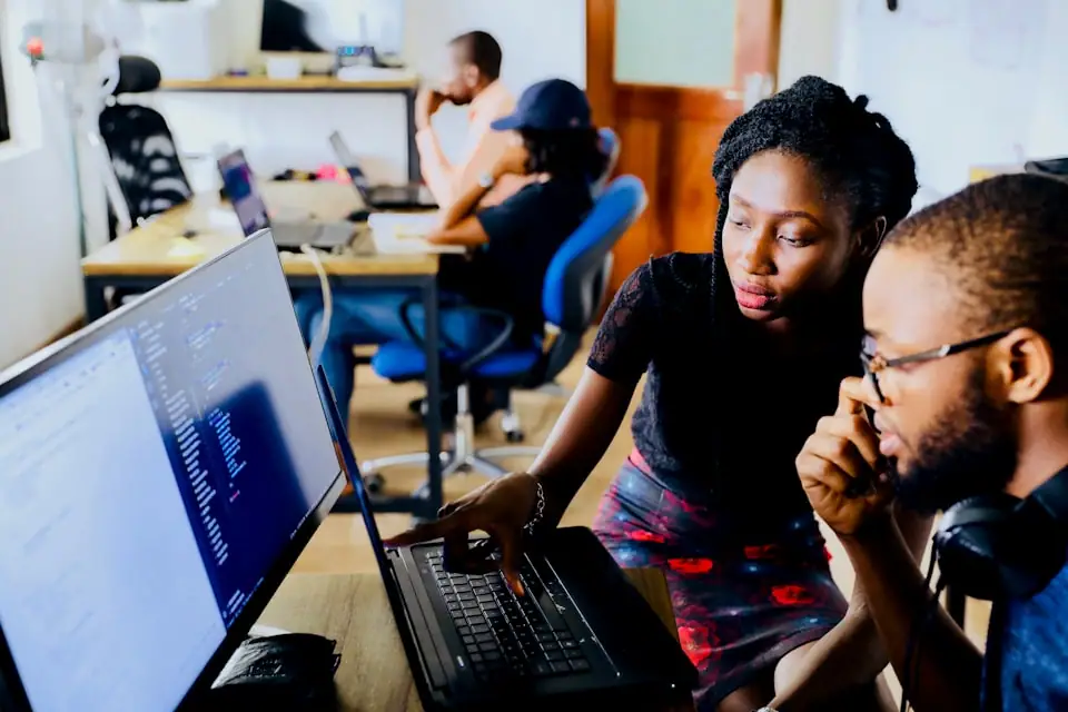 Mentor supporting an intern at a desk